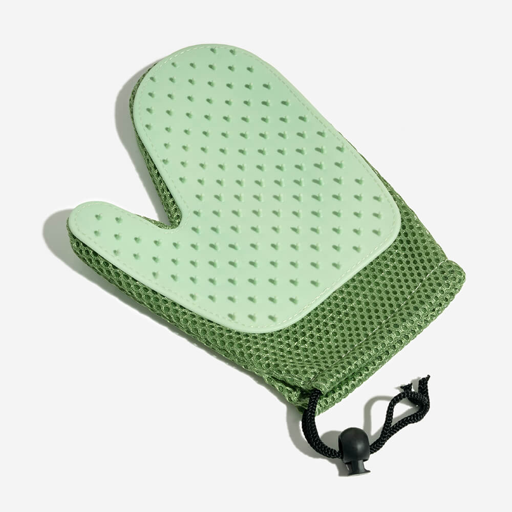 Silicone pet grooming glove in use, showing its dual-sided design for effective hair removal.