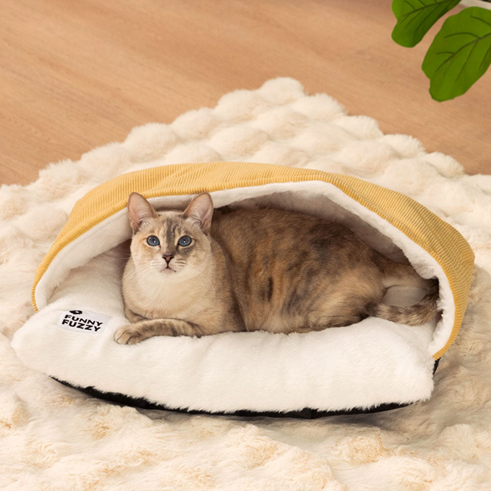 A gray tabby curled inside the fuzzy cat bed, showcasing its plush interior and snug design