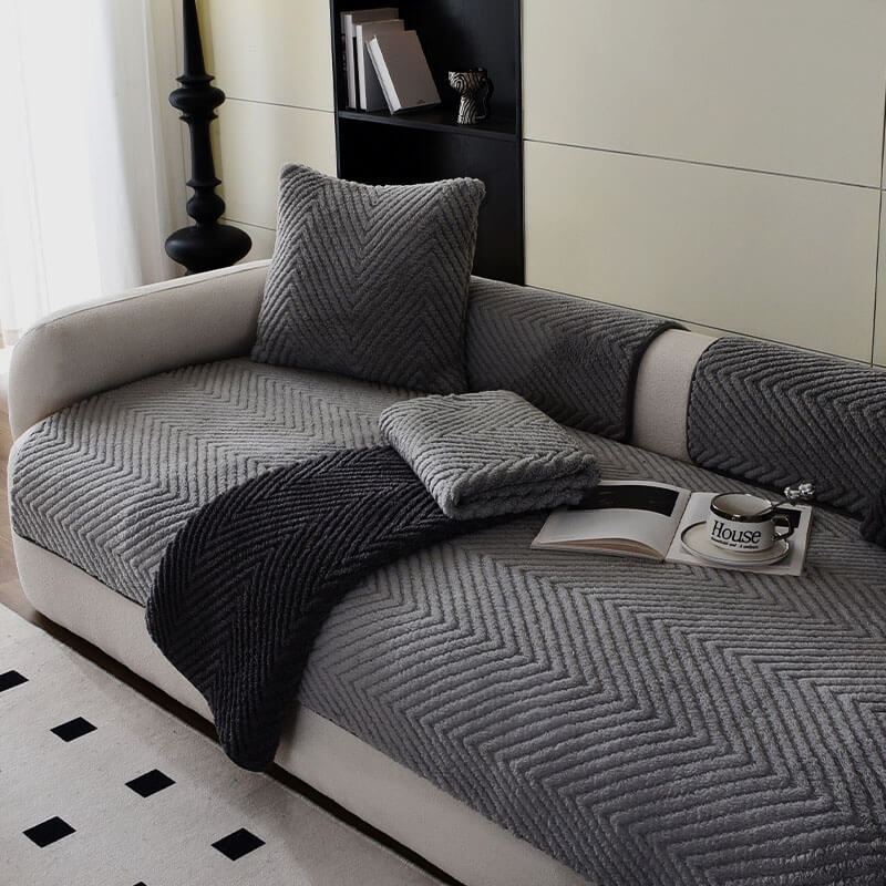 CozyGuard Plush Leather Sofa Cover on a leather sofa, showcasing its non-slip bottom and stylish herringbone pattern.