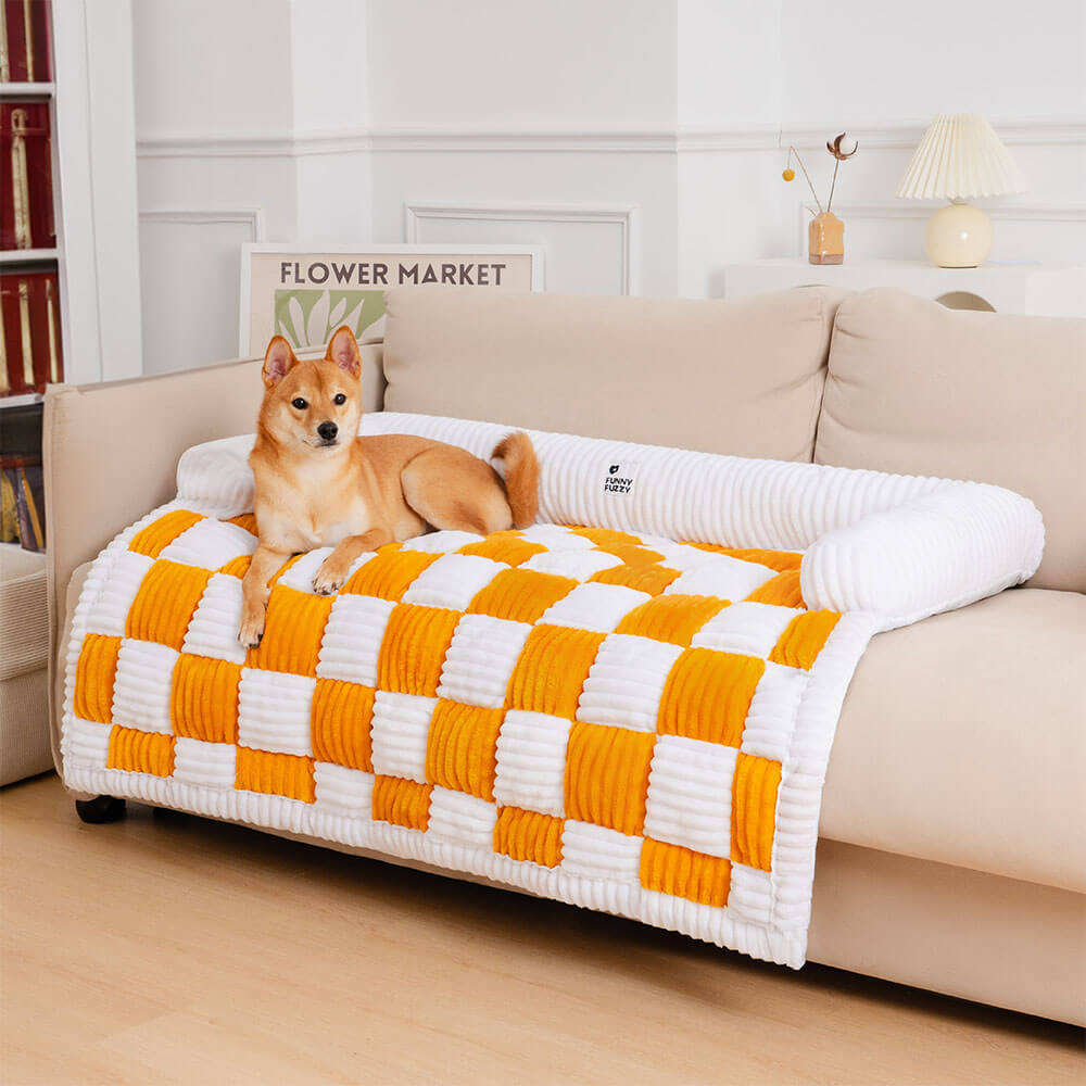 A dog comfortably napping on a cream plaid pet furniture protector draped over a light-colored sofa, showcasing its cozy design.