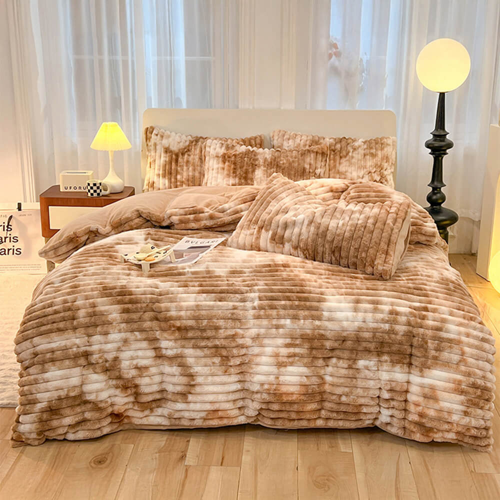 Artistic gradient faux rabbit fur bed sheet set displayed on a neatly made bed, showcasing its softness.