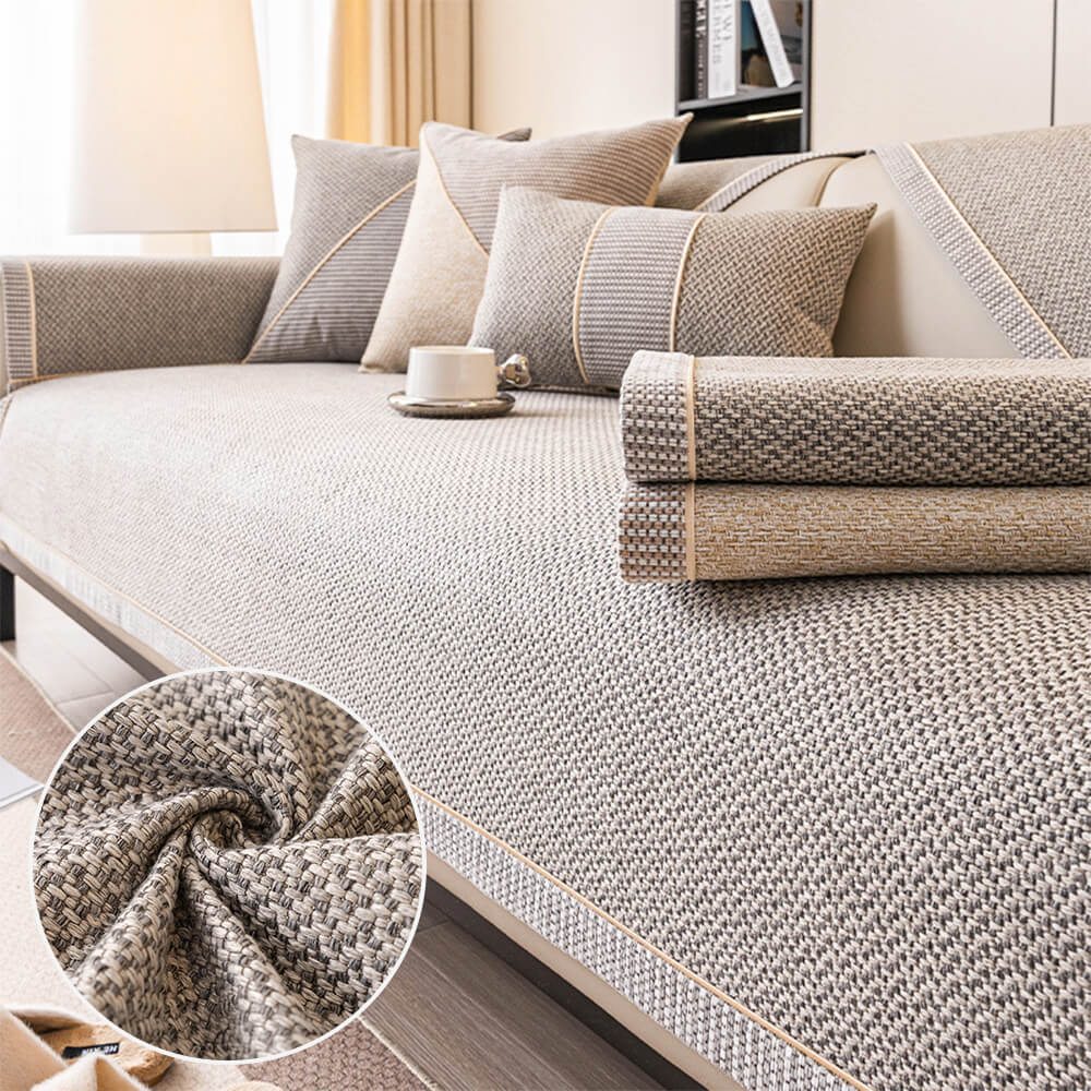 Cotton linen sofa cover draped over a gray couch with decorative pillows