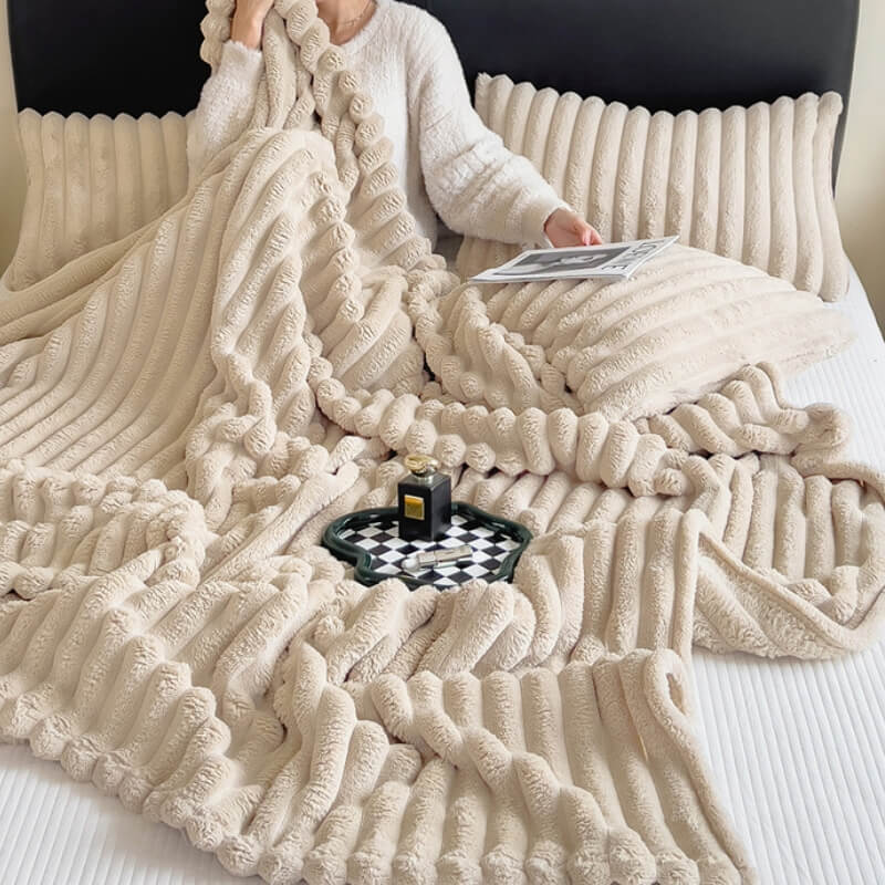 Cozy faux rabbit plush sofa throw blanket draped on a couch, showcasing its soft texture and warmth.