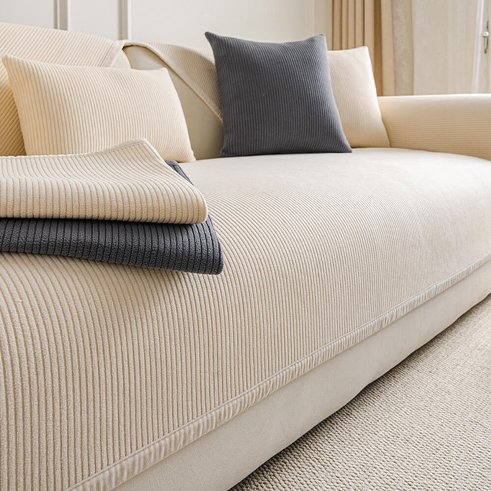 Cream fleece sofa protector with modern vertical stripes, perfect for pet owners.