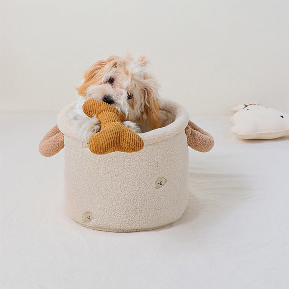 Close-up of a plush dog toy storage basket with handles in a cozy home setting