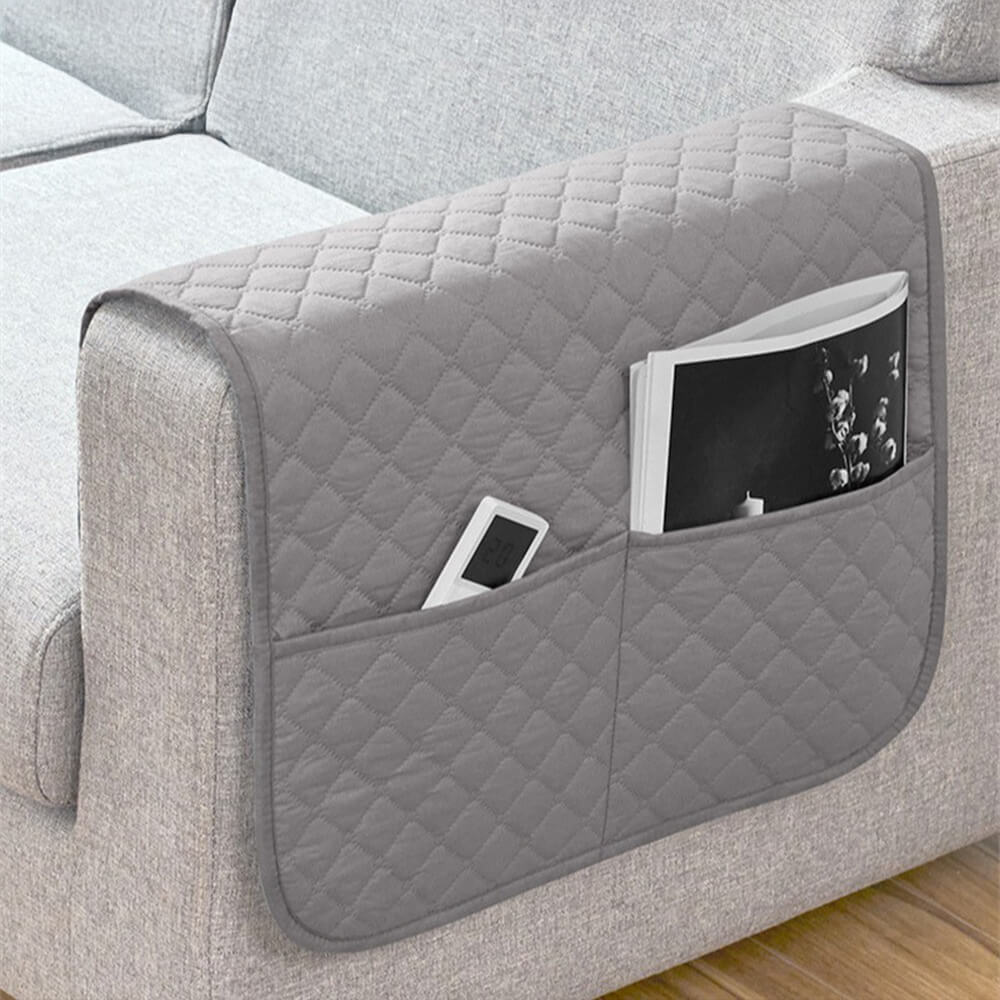 Waterproof quilted sofa armrest cover with storage pockets, protecting your sofa from spills and wear.