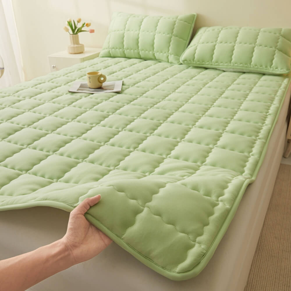 Luxury all-season quilted mattress topper displayed on a bed, highlighting its breathable fabric.