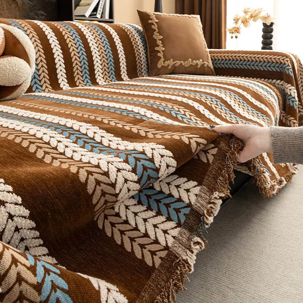 Close-up of a vibrant Evergreen Leaf Chenille Sofa Protector Throw draped over a couch, highlighting the intricate embroidery and soft texture.
