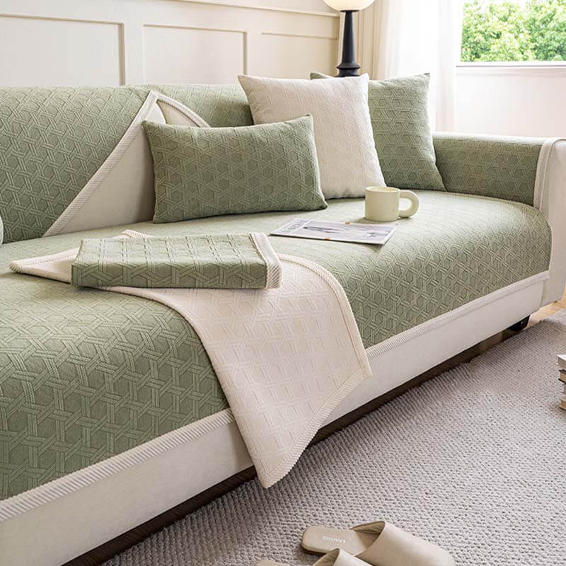 A close-up of a luxurious jacquard chenille fabric sofa protector with silicone bottom, showing its textured weave and the non-slip grip.