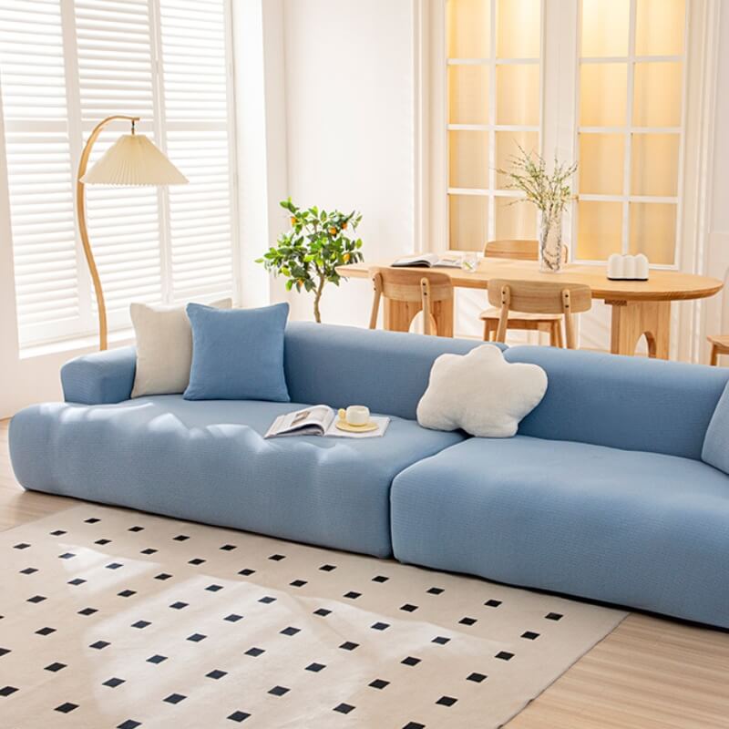 Front view of the waterproof stretch sofa cover on a 3-seater couch, showing snug fit and smooth texture.