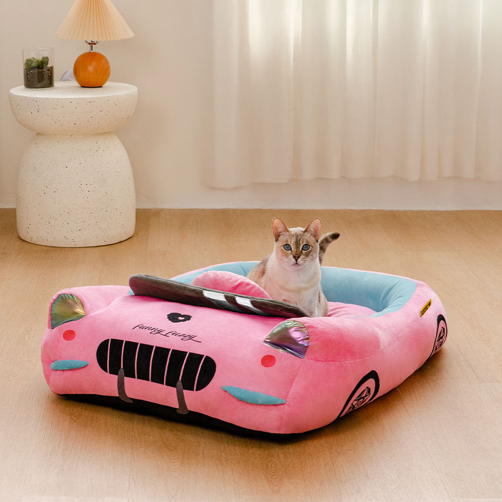 Top view of convertible cat bed shaped like a red race car with bolster accents.