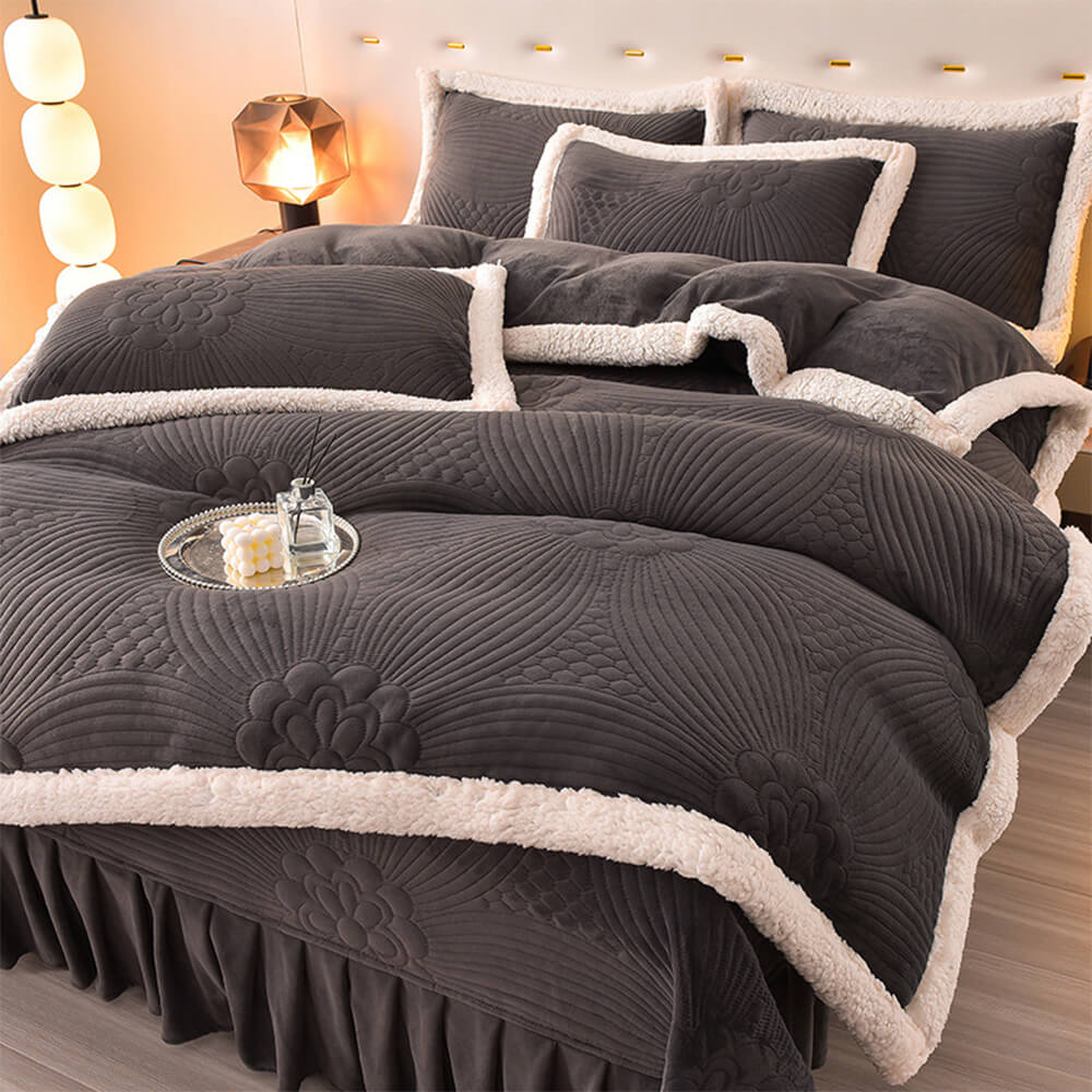 Close-up of floral quilted fleece bedding set draped over a bed