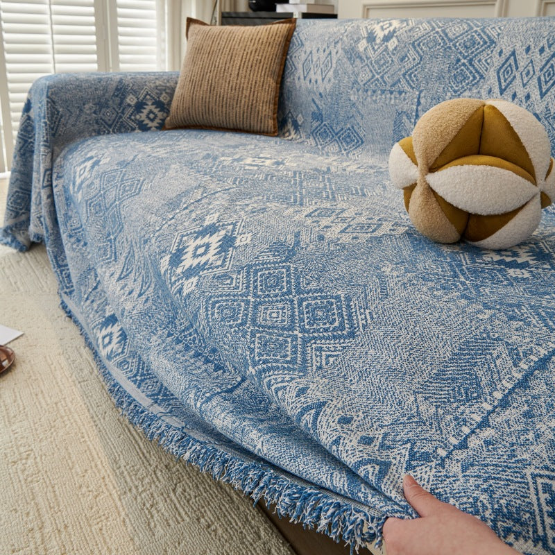 Reversible chenille couch blanket for dogs styled on a modern sofa with pets lounging