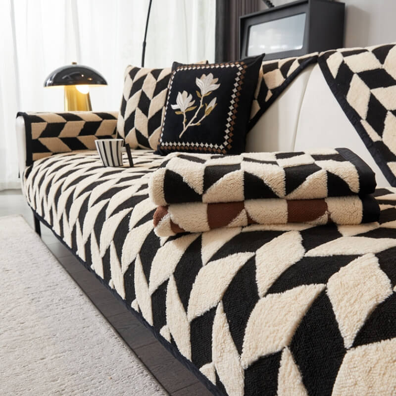 A vibrant, close-up shot of the plush sofa cover showcasing its modern diamond pattern and soft, velvety texture on a large couch.