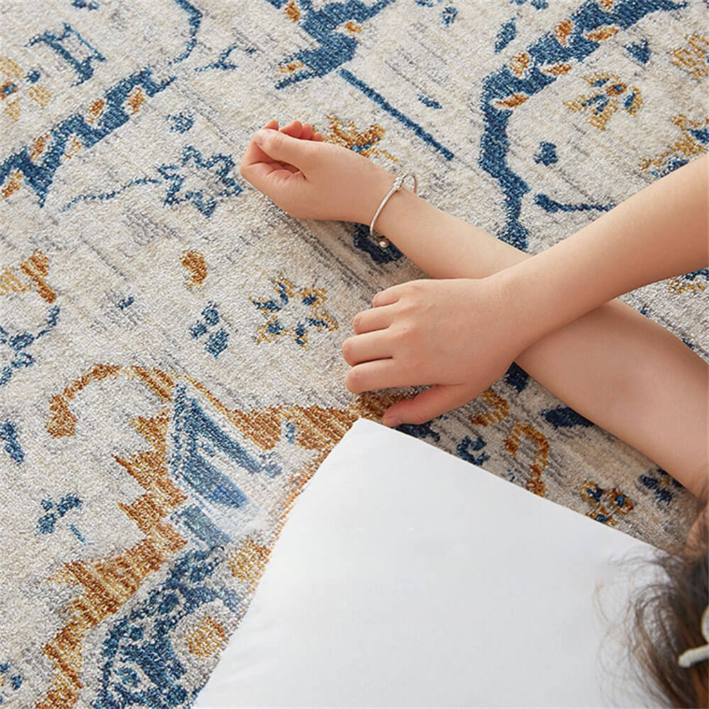 Overhead view of the blue and cream Persian area rug placed in a bright living room corner