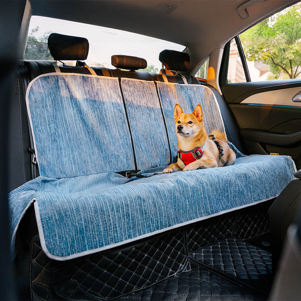 Front view of chenille pet seat cover installed in a sedan with dog sitting comfortably