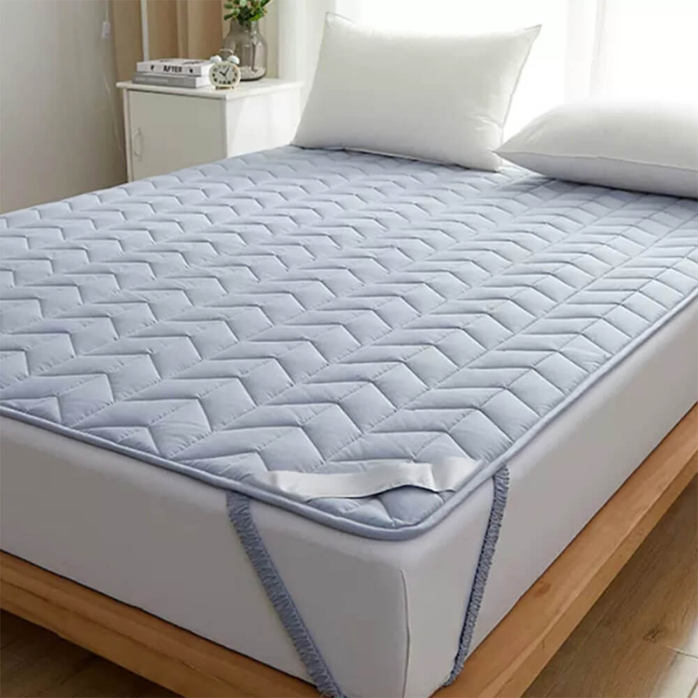 ComfortCotton mattress topper on a bed, showcasing its soft and breathable cotton surface.