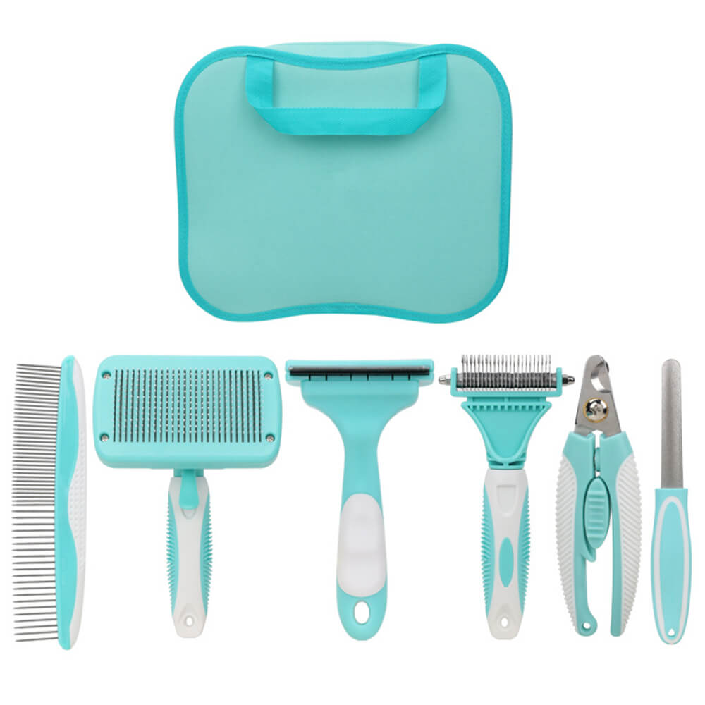 Dog grooming tools including slicker brush, nail clipper, and comb arranged on a grooming table