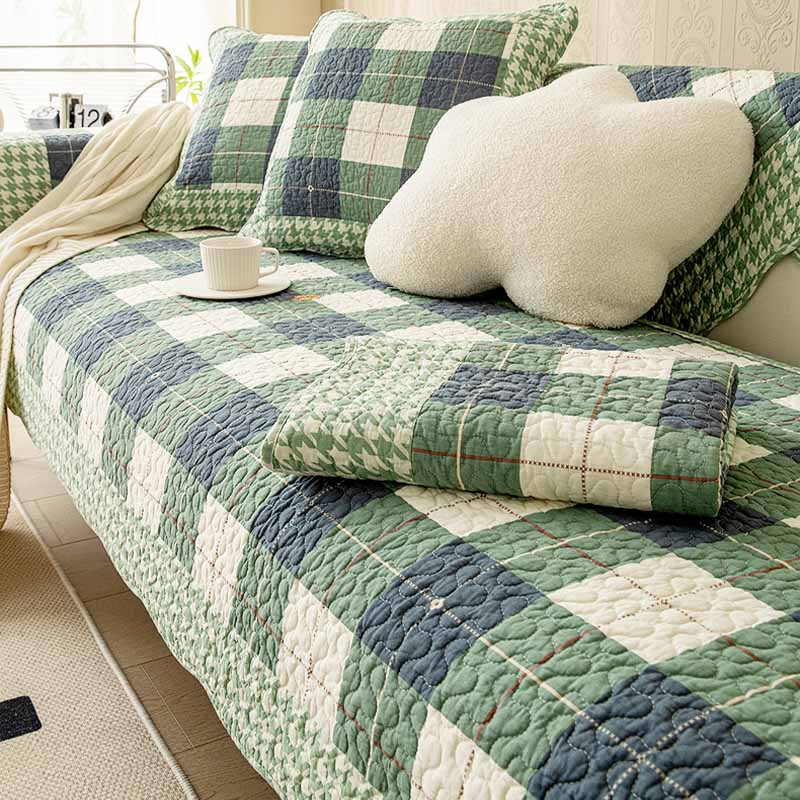 Plaid cotton sofa cover draped neatly over a sectional sofa, showcasing its textured design.