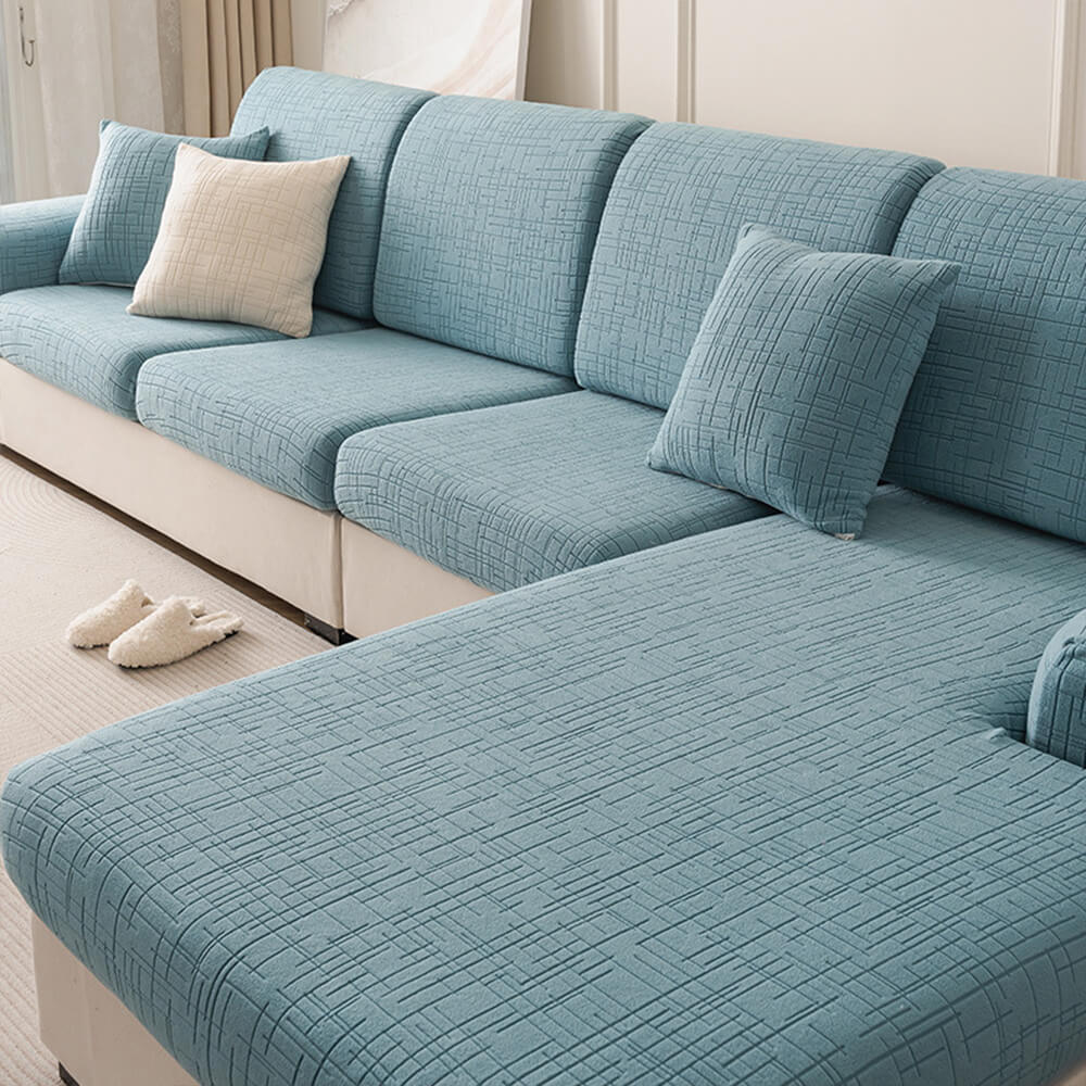 Velvet soft furniture protector draped over a modern sofa highlighting breathable jacquard plush fabric