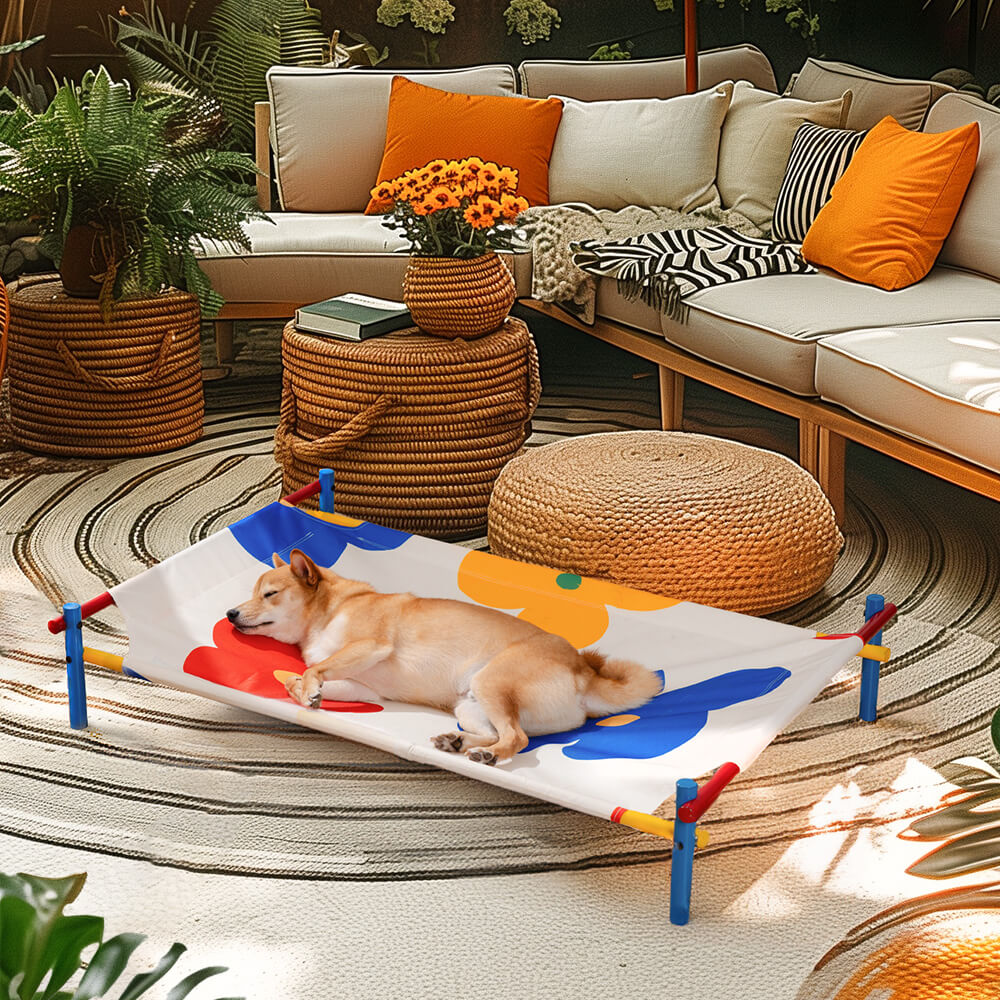 Top-down view of aluminum dog bed in vibrant summer print placed in a shaded garden corner