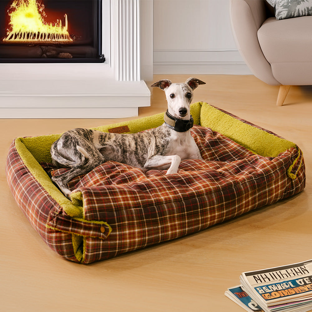 Large tartan dog bed folded on a hardwood floor, showing washable cover