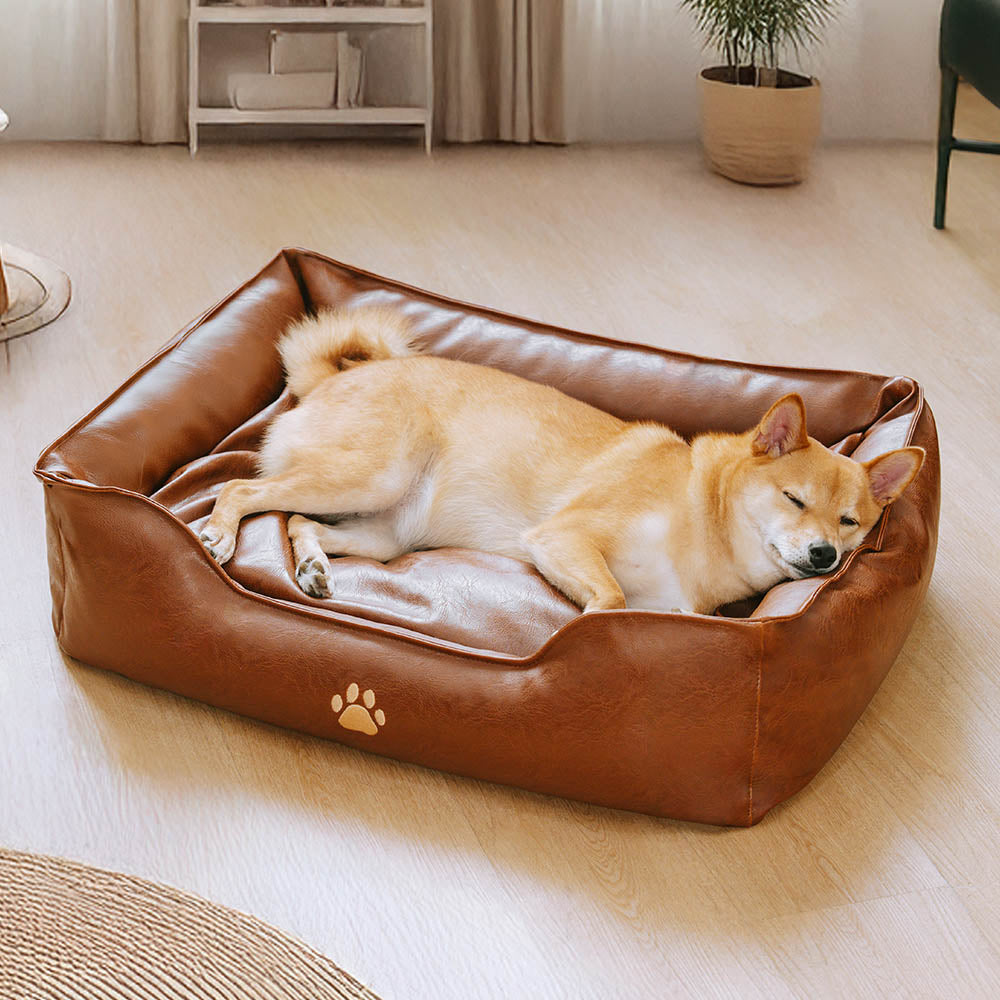 Stylish faux leather waterproof dog sofa bed with bolsters, perfect for cozy lounging.