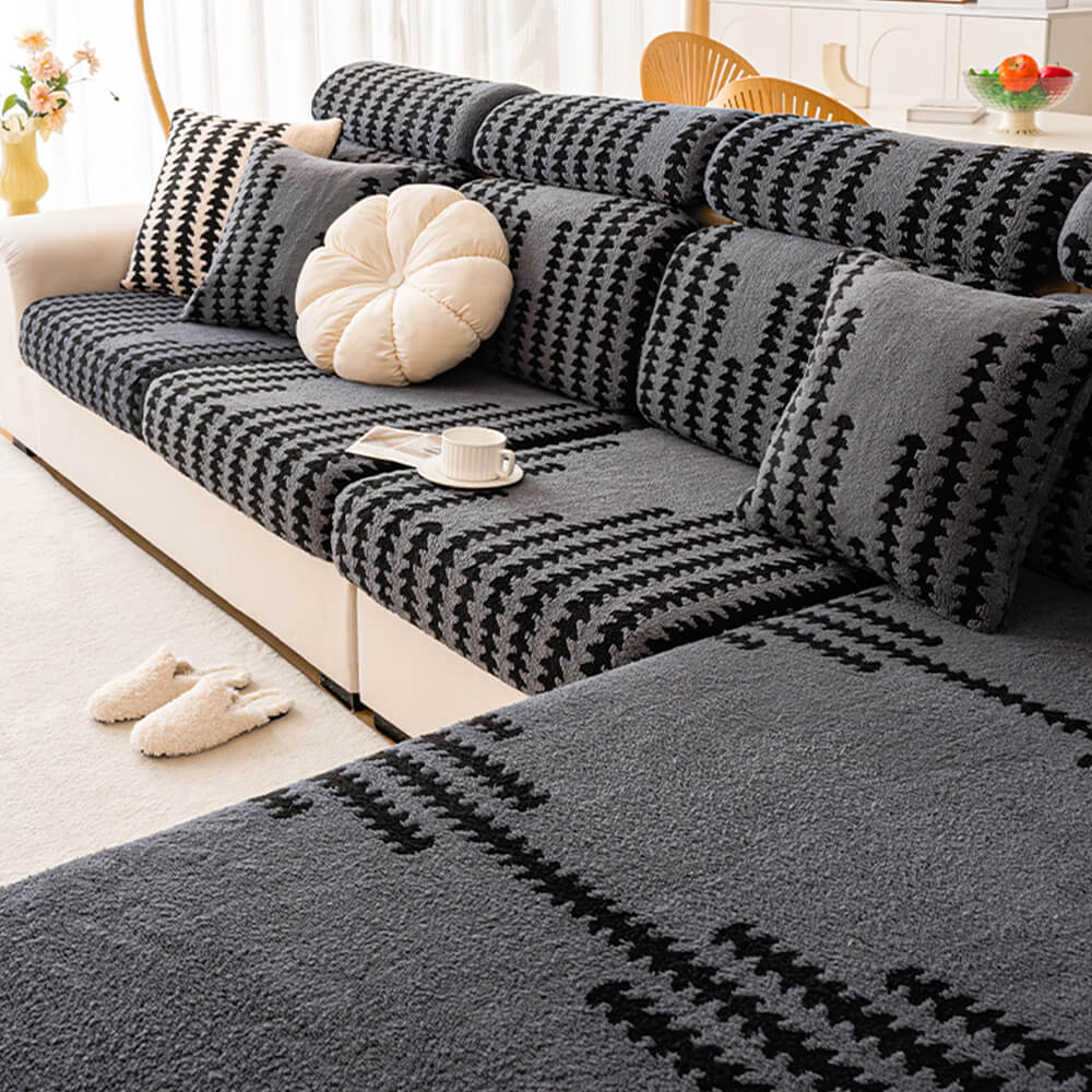 Chic fishbone striped sofa cover draped over a modern couch, showcasing its fit and design.