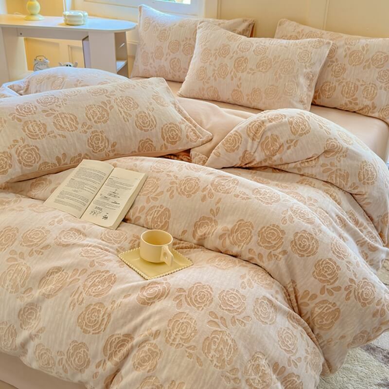 Angle view of bed styled with soft milk velvet sheets and carved rose details.