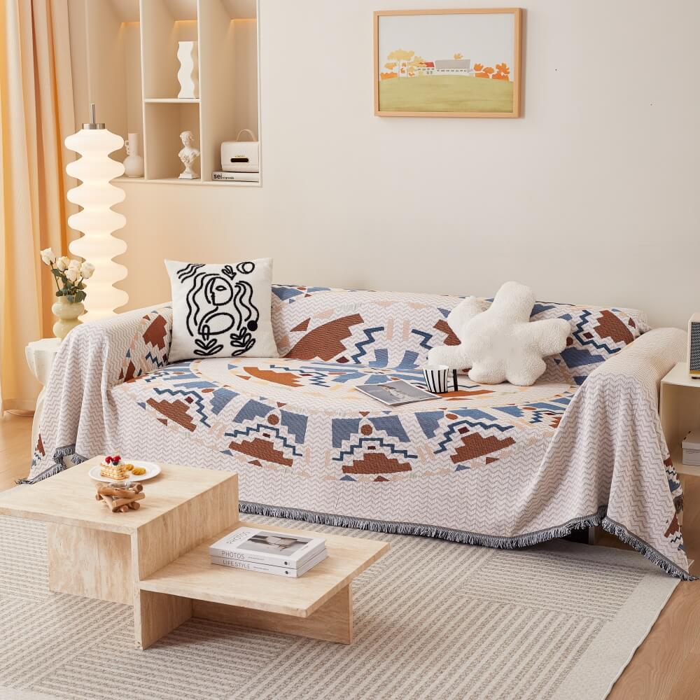 Bohemian couch cover draped over a modern sofa, showcasing vibrant colors and patterns.