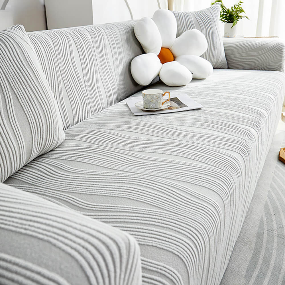 Close-up of Jacquard stretch sofa cover showing its elasticity and anti-scratch fabric