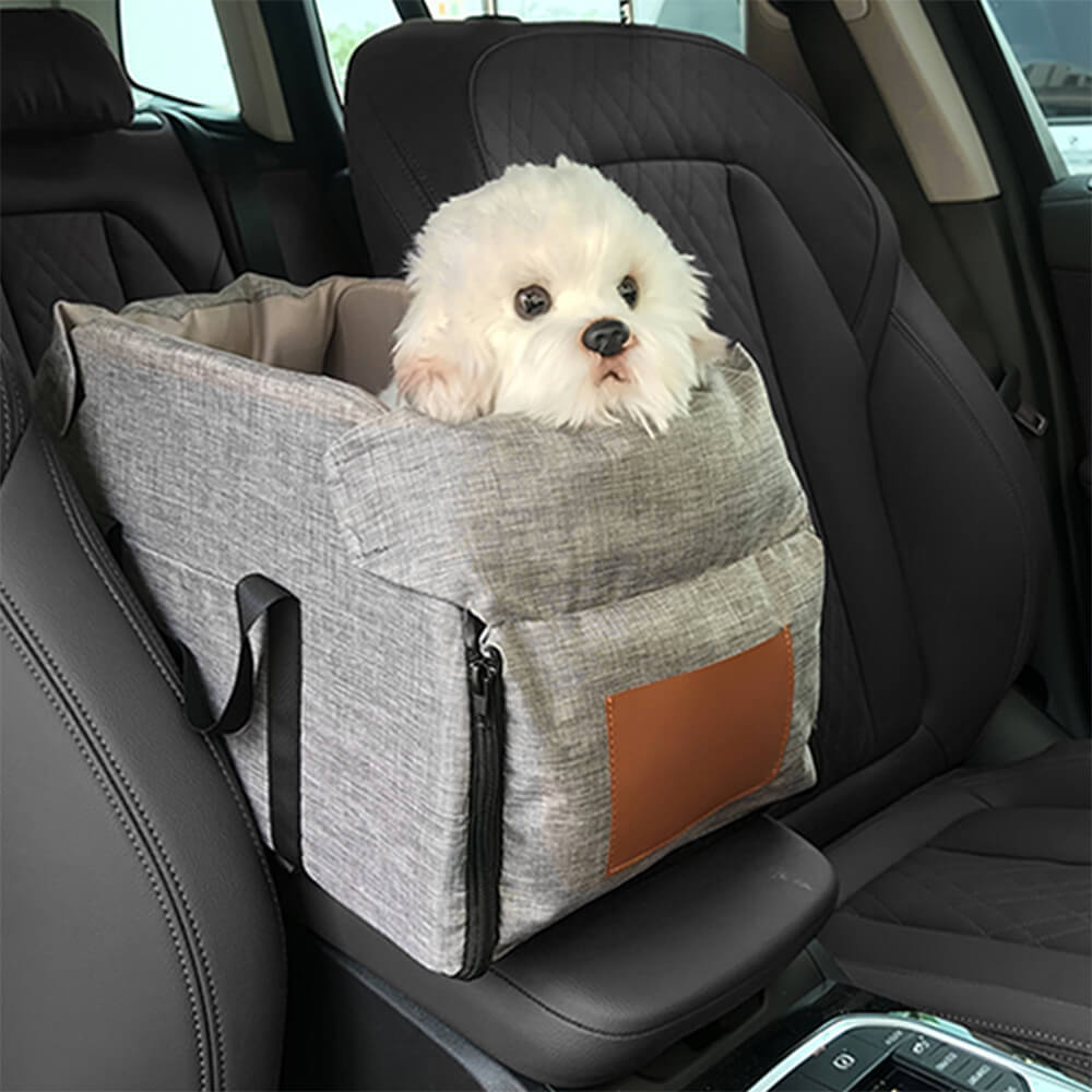 Gray pet car seat installed in SUV with dog resting inside