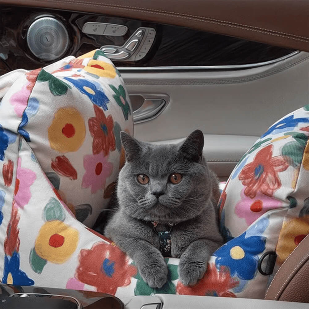 Top-down view of the hand-painted pet car seat showing floral detailing and safety clip