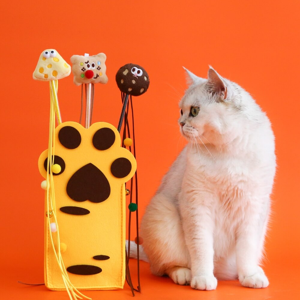 Close-up of cookie-shaped cat teaser stick with colorful tassels, perfect for interactive cat toys