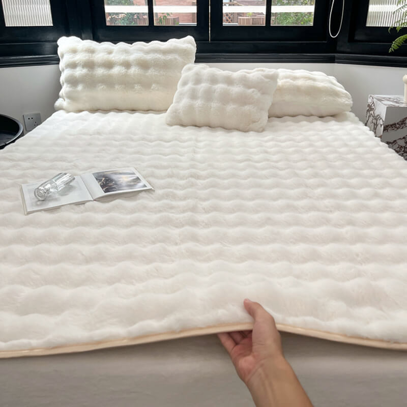 Close-up of plush faux rabbit fur mattress protector showing soft texture