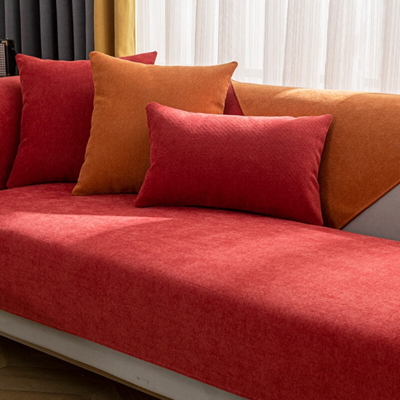 Vibrant vermilion chenille sofa cover draped elegantly over a couch, showcasing its rich texture.