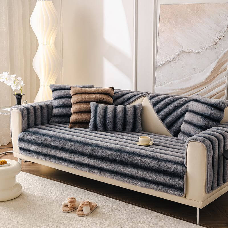 Close-up of striped faux rabbit fur sofa cover draped over a modern couch