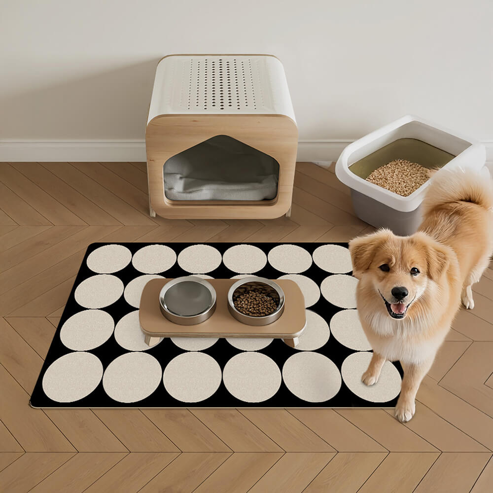 Overhead view of the GeoGrip absorbent pet mat placed under a dog bowl, showing water absorption in progress