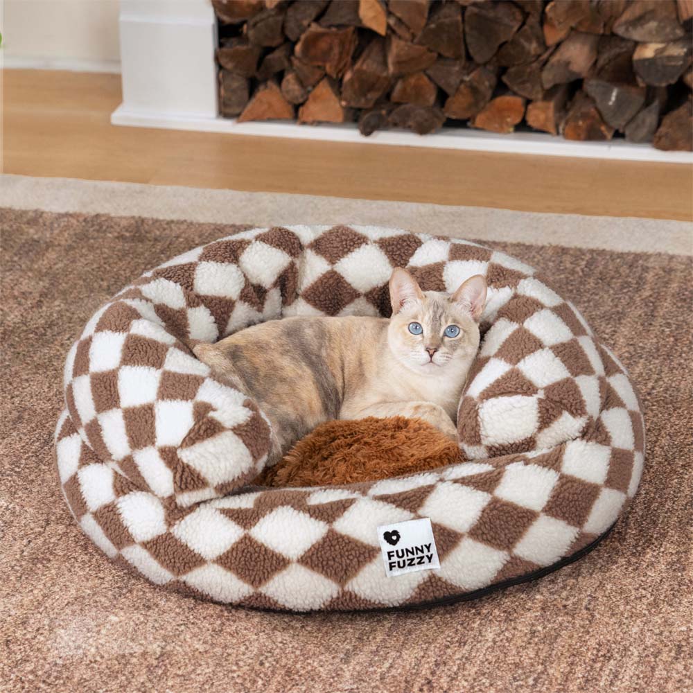 Close-up of cozy argyle washable bolster donut cat bed in soft plush fabric