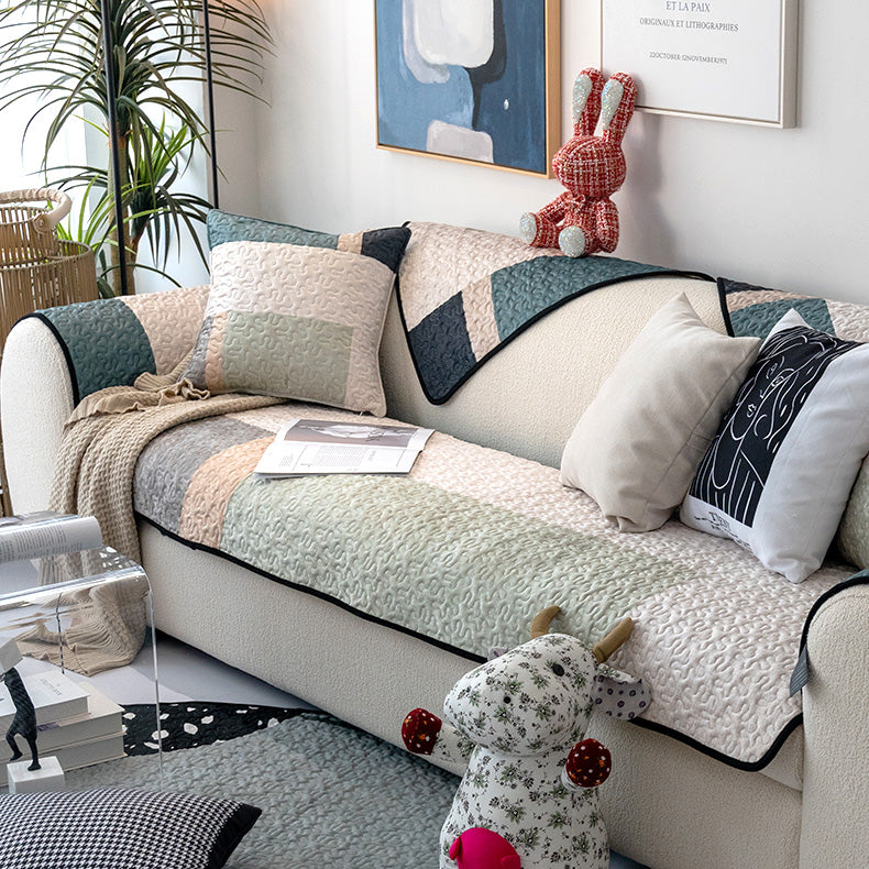 Top view of CottonGuard sofa cover showing textured cotton fabric and stitched edges