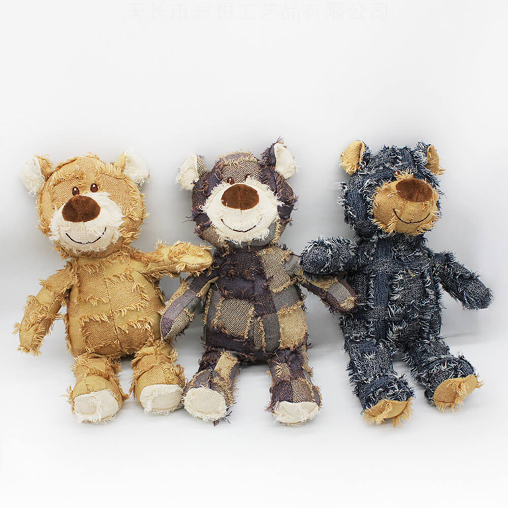 Front view of the plush bear dog toy, showcasing its denim texture and squeaker.