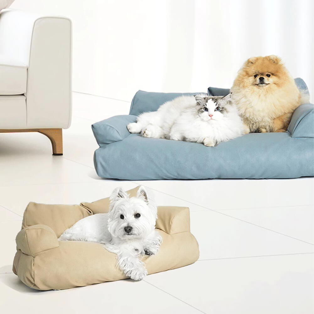 Angled side view of faux leather dog bed placed beside a window with natural light