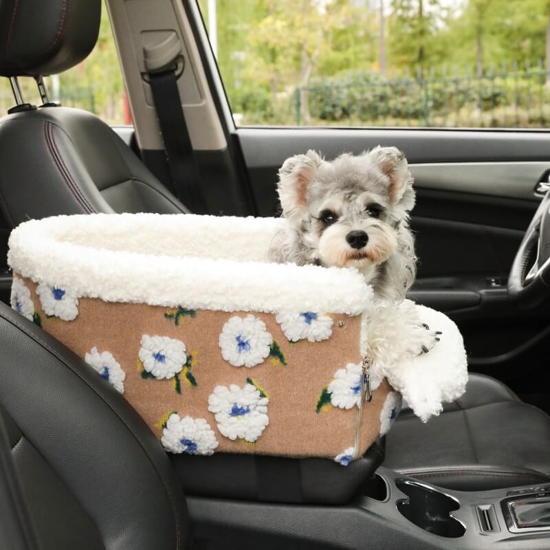 Close-up of floral-stitched fleece dog car seat on vehicle console