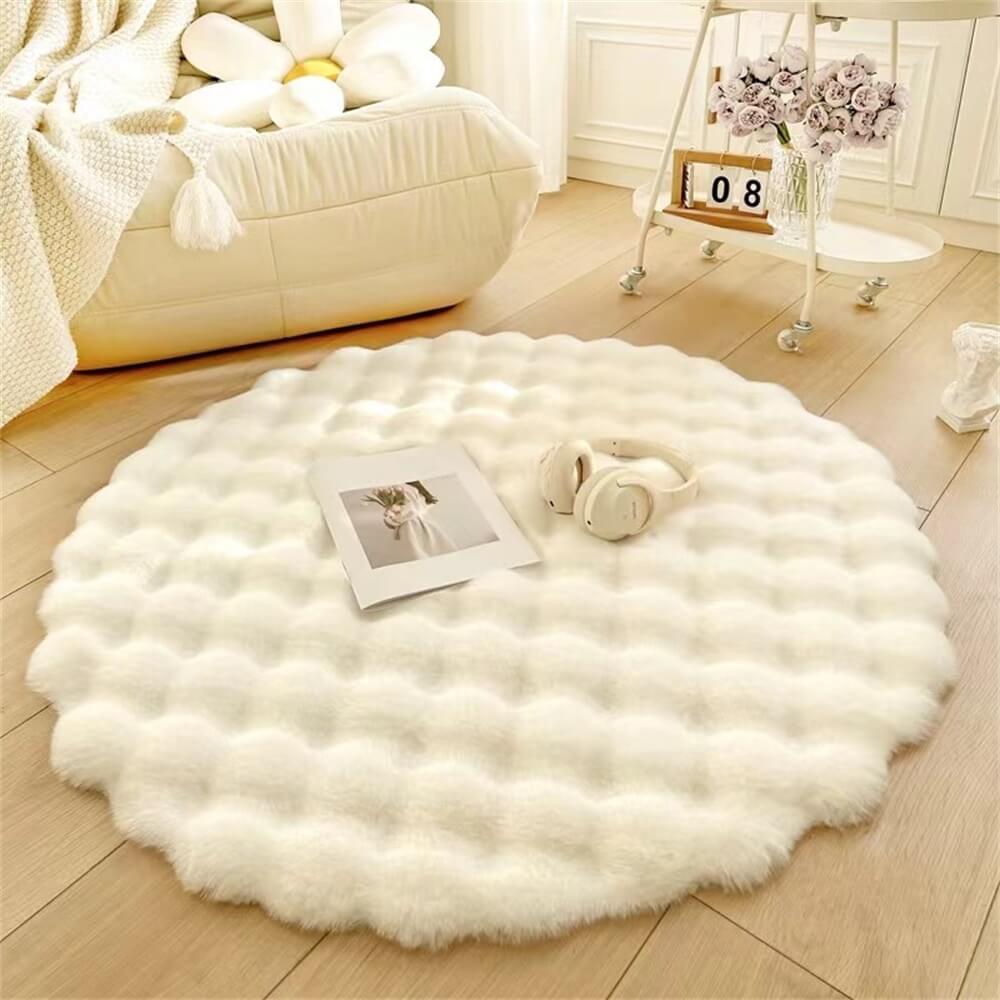 Top-down view of the CloudNest round rug in creamy beige placed in a sunlit reading nook