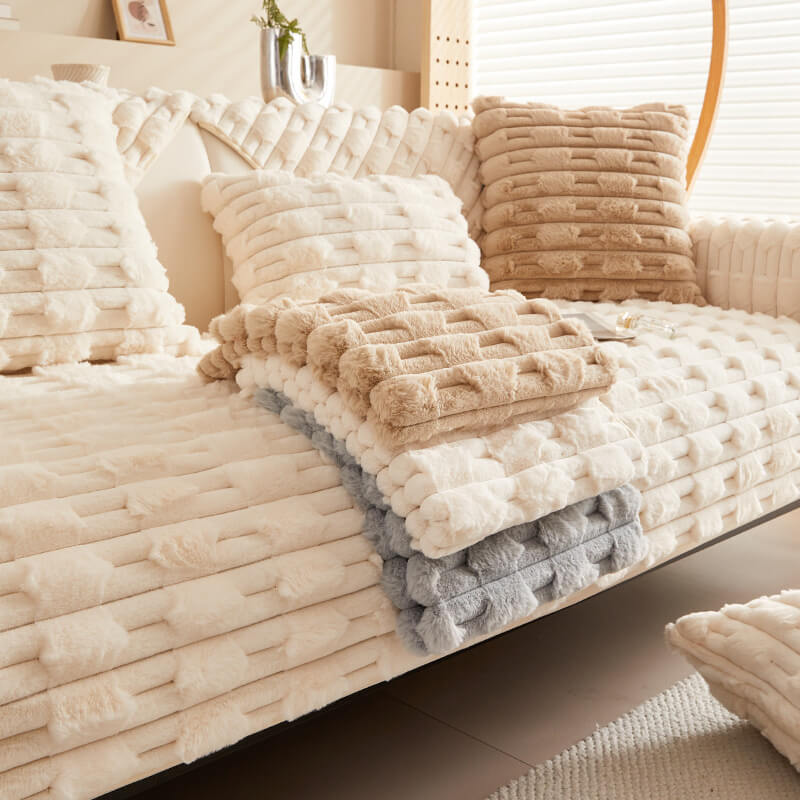A cozy living room setting featuring a striped plush couch cover draped over a sofa, illustrating its luxurious texture and effective furniture protection.