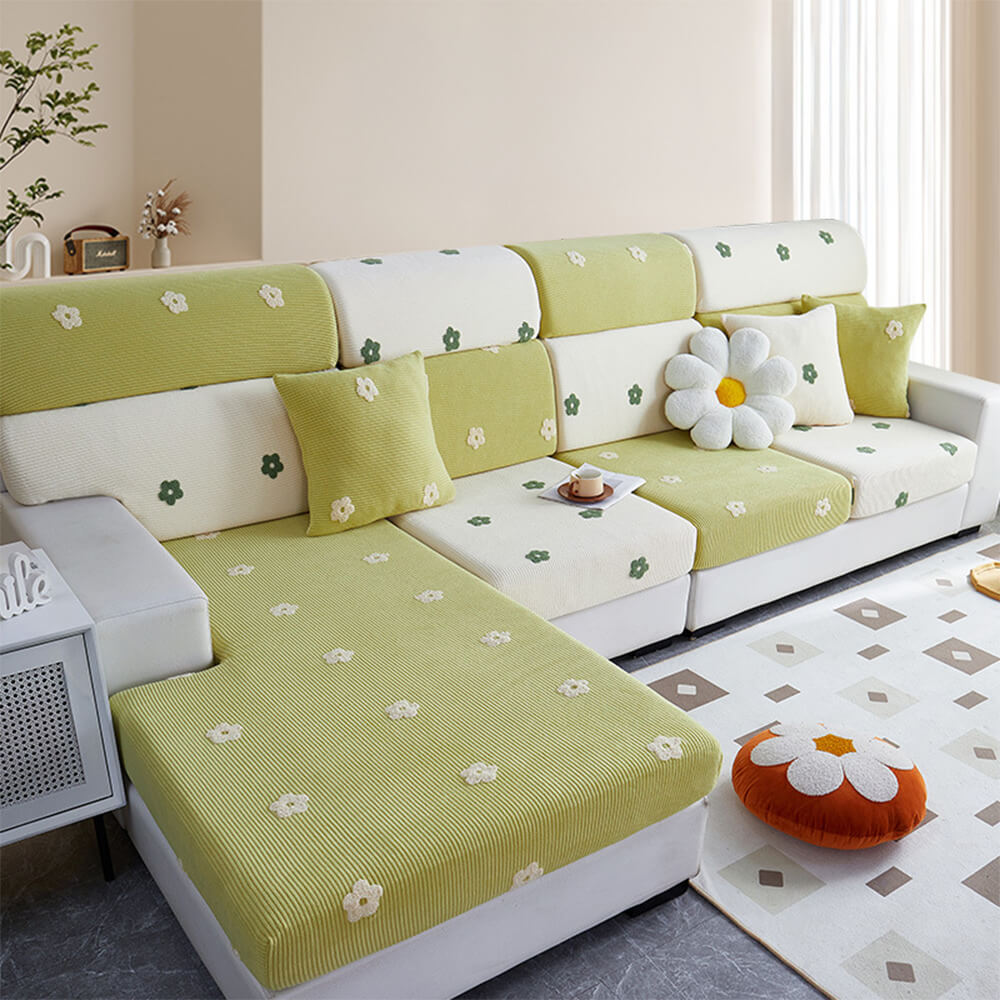 Front angle showing floral embroidered couch cover draped over a three-seater sofa in a cozy living room.