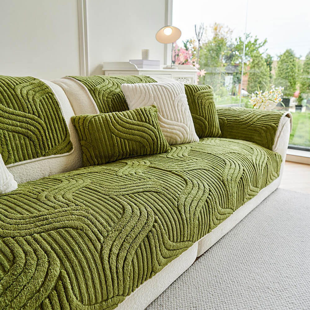 Top-down view of sofa with GeoPlush cover showing geometric pattern and snug fit for pet protection