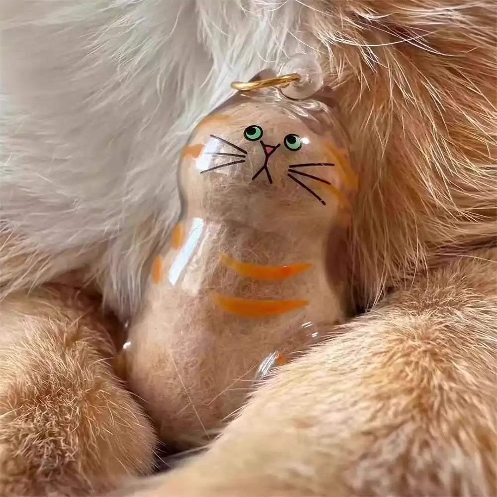 Close-up of a dog-shaped pet hair keychain on a keyring