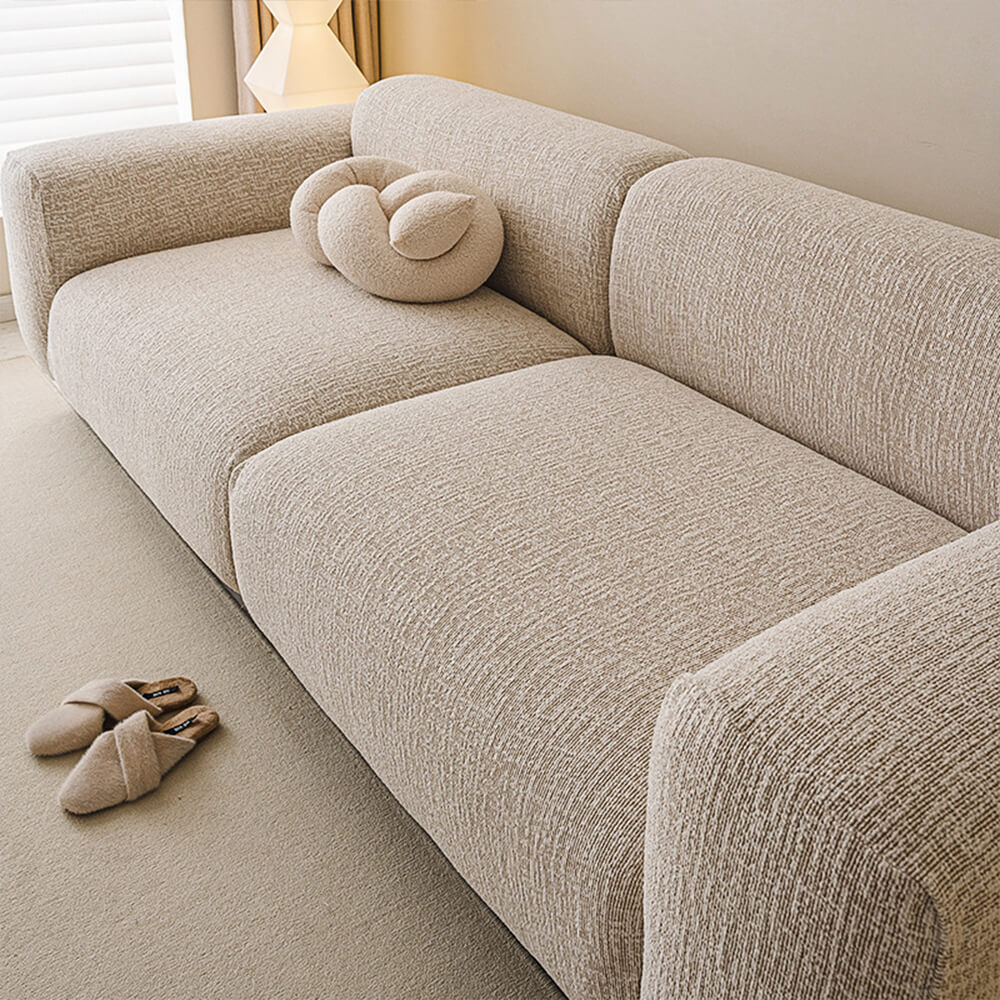 Close-up of soft chenille fabric on sofa cover showing plush texture and durability