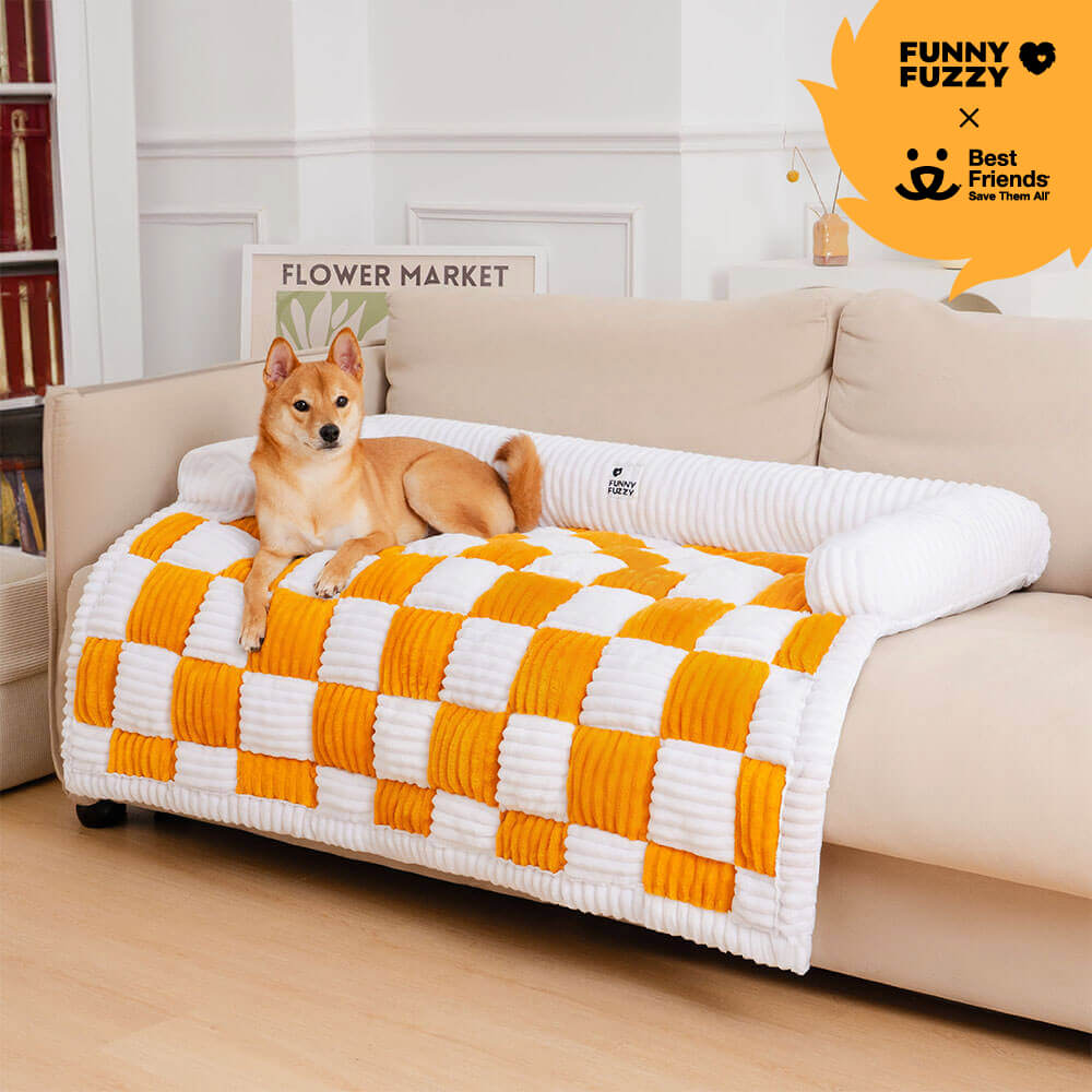 CozyPaws Cream Plaid Dog Mat on a couch, showcasing its comfort and style